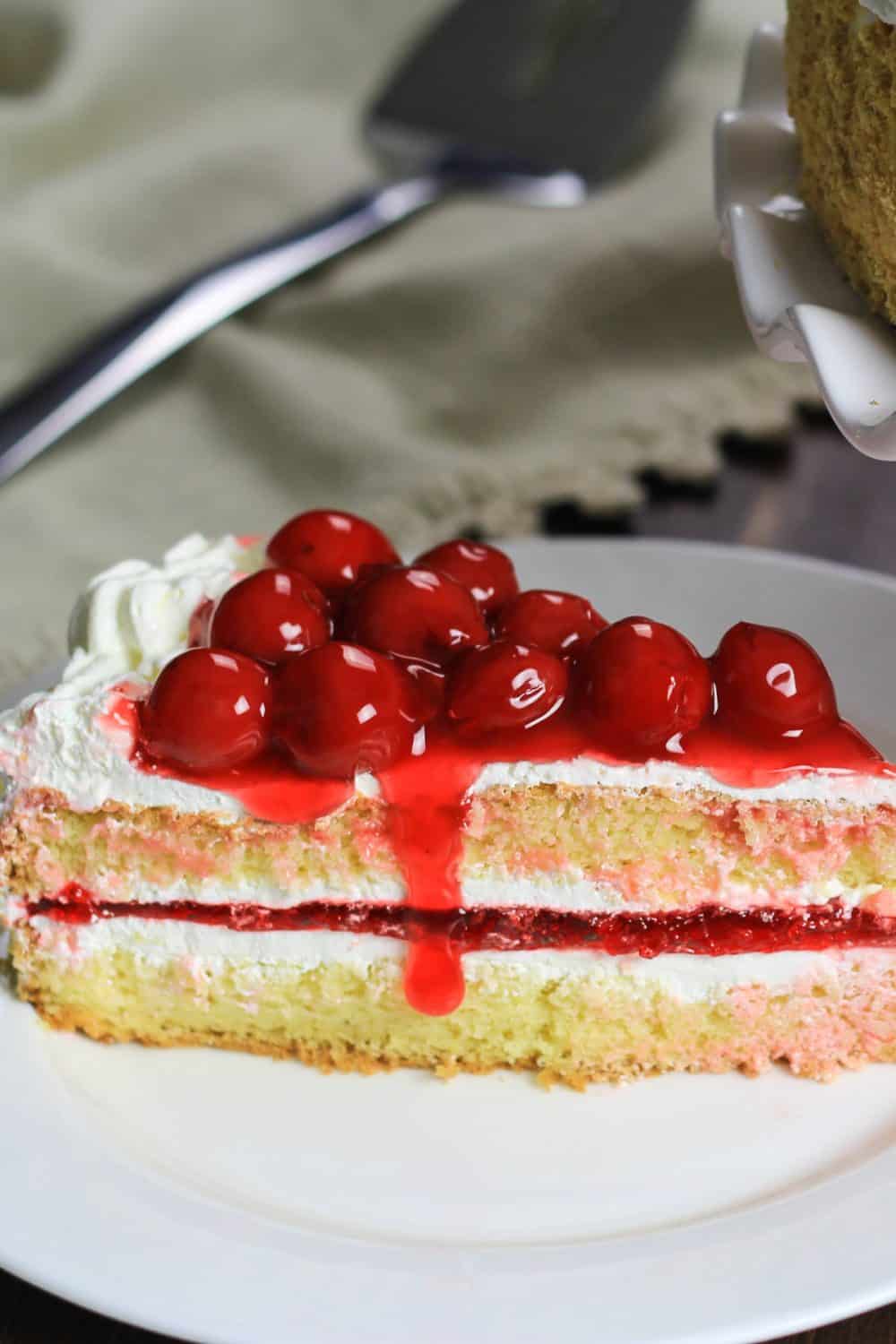 This Cherry Jello Cake Recipe is one of my favorite summertime desserts! A homemade cake and layers of sweet cherry filling make it a hit you feel good serving. #jellocake #cherryjello #spongecake #cherrypiecake #cherrycake