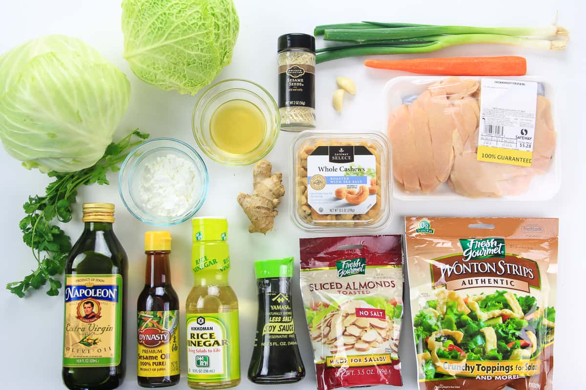 crunchy asian chicken salad recipe with simple ingredients that are so easy to throe together. #asianchickensalad #chinesechickensalad #asiansalad #sesamesalad #chickensalad an overhead image of ingredients needed for Asian chicken salad on a white background