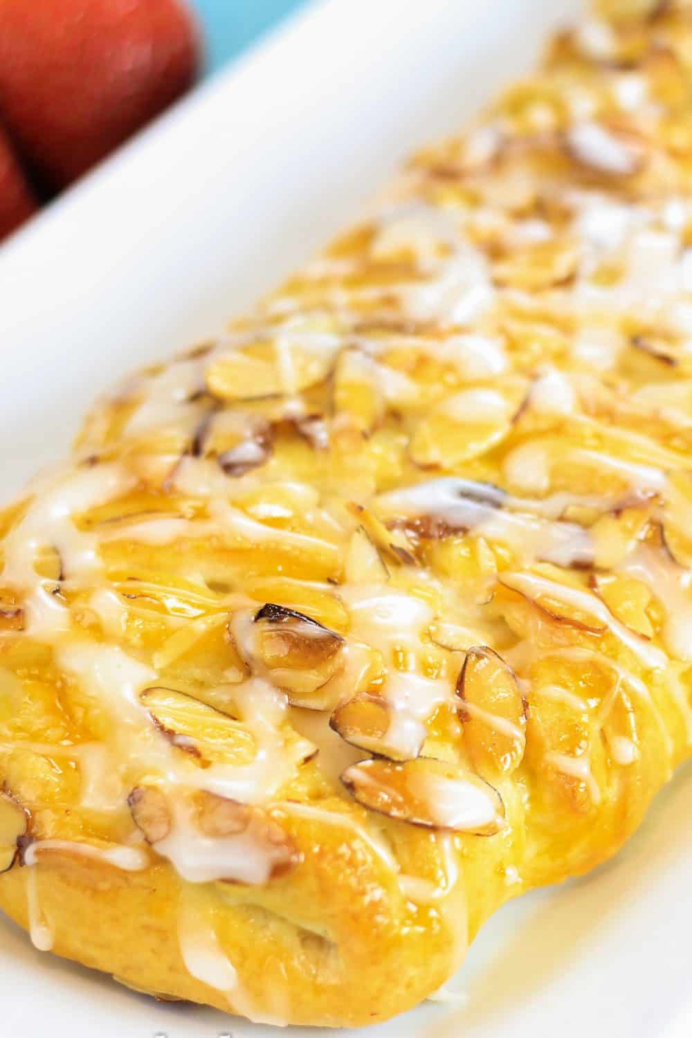 This Danish Recipe with Almonds and Cream Cheese is a perfect easy treat to make and serve with your favorite cup of coffee.  #danishrecipe #homemadedanish #danishdough #almonddanish #braideddanish Almond and cream cheese danish recipe whole and laying on a large white platter