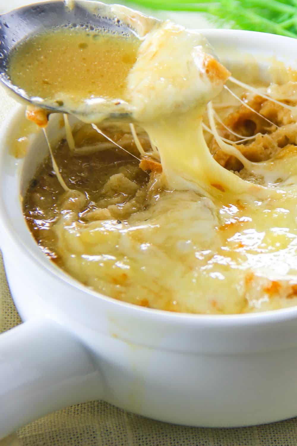 A delicious cheese pull from a flavorful french onion soup.