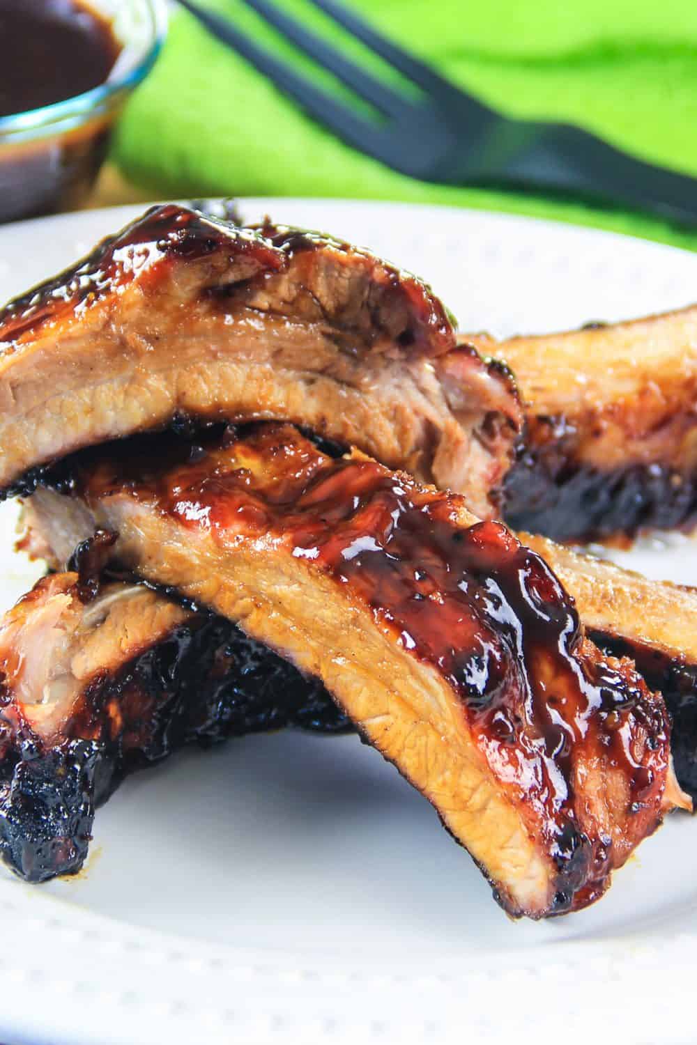 sliced barbecue ribs on a white plate