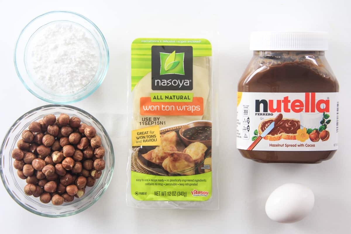 Ingredients for nutella wonton recipe displayed on flat surface. 