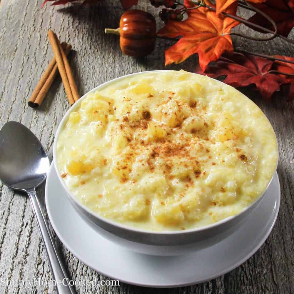 This simple rice pudding recipe is the perfect comfort dish for fall since its loaded with cubes of sweet spaghetti squash. The flavors are truly amazing! #ricepudding #fallrecipe #fallbreakfast pumpkin rice pudding in a white bowl with cinnamon on top