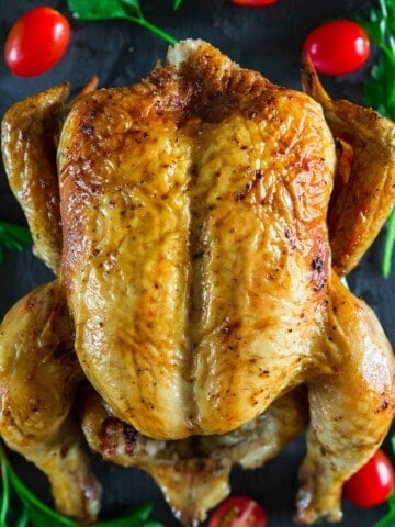 oven roasted chicken with cherry tomatoes beside it