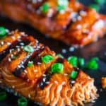 grilled teriyaki salmon with green onion and sesame seeds on top