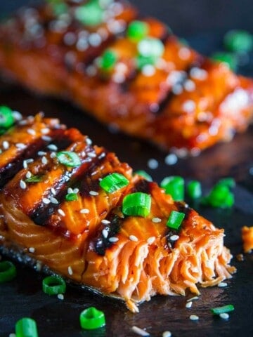 grilled teriyaki salmon with green onion and sesame seeds on top