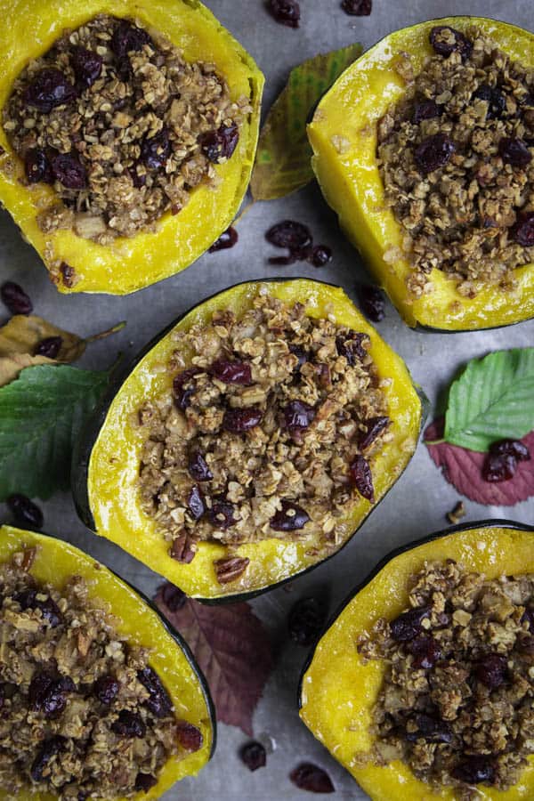 An easy and delicious breakfast recipe consisting of roasted acorn squash stuffed with fall-flavored oatmeal #acornsquash #stuffedsquash #fallbreakfast #cinnamonoatmeal an overhead image of baked acorn squash stuffed with oatmeal