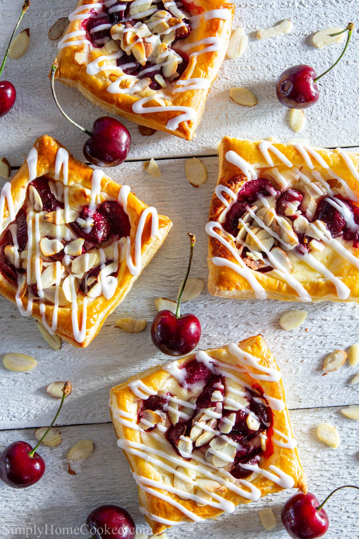 Cherry Danishes among cherries and almond slivers.