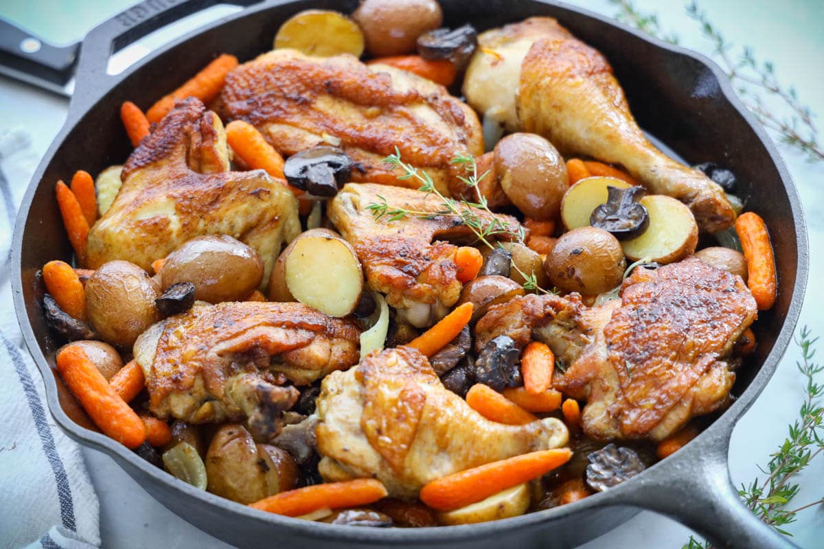 Cast iron skillet of One Pan Chicken and Potatoes.