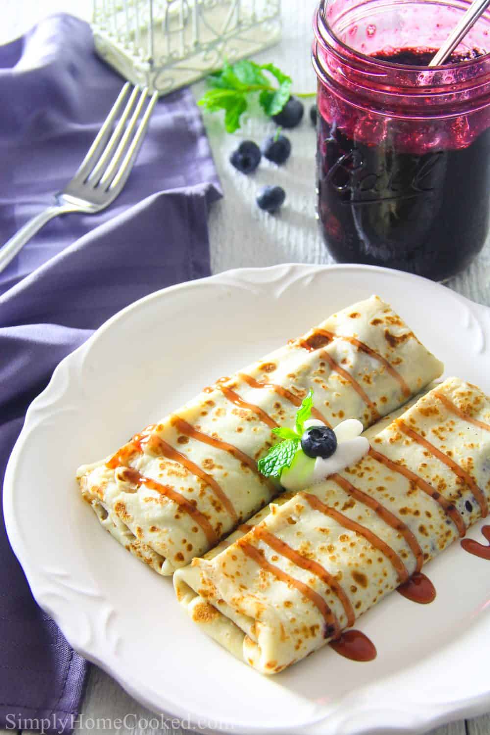 Delicious crepes filled with homemade blueberry pie filling. This blueberry crepe recipe is an easy and quick dessert everyone will love. #crepes #creperecipe #easycrepes #blueberrycrepes Fill this amazing Blueberry Breakfast Crepe Recipe with our own homemade blueberry pie filling for a simple but delicious breakfast or dessert that is a show stopper!