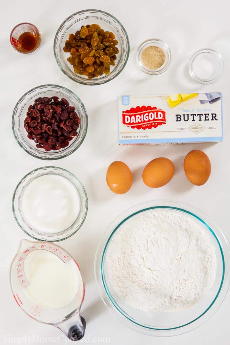 overhead image of ingredients for brioche hot cross buns on a white background