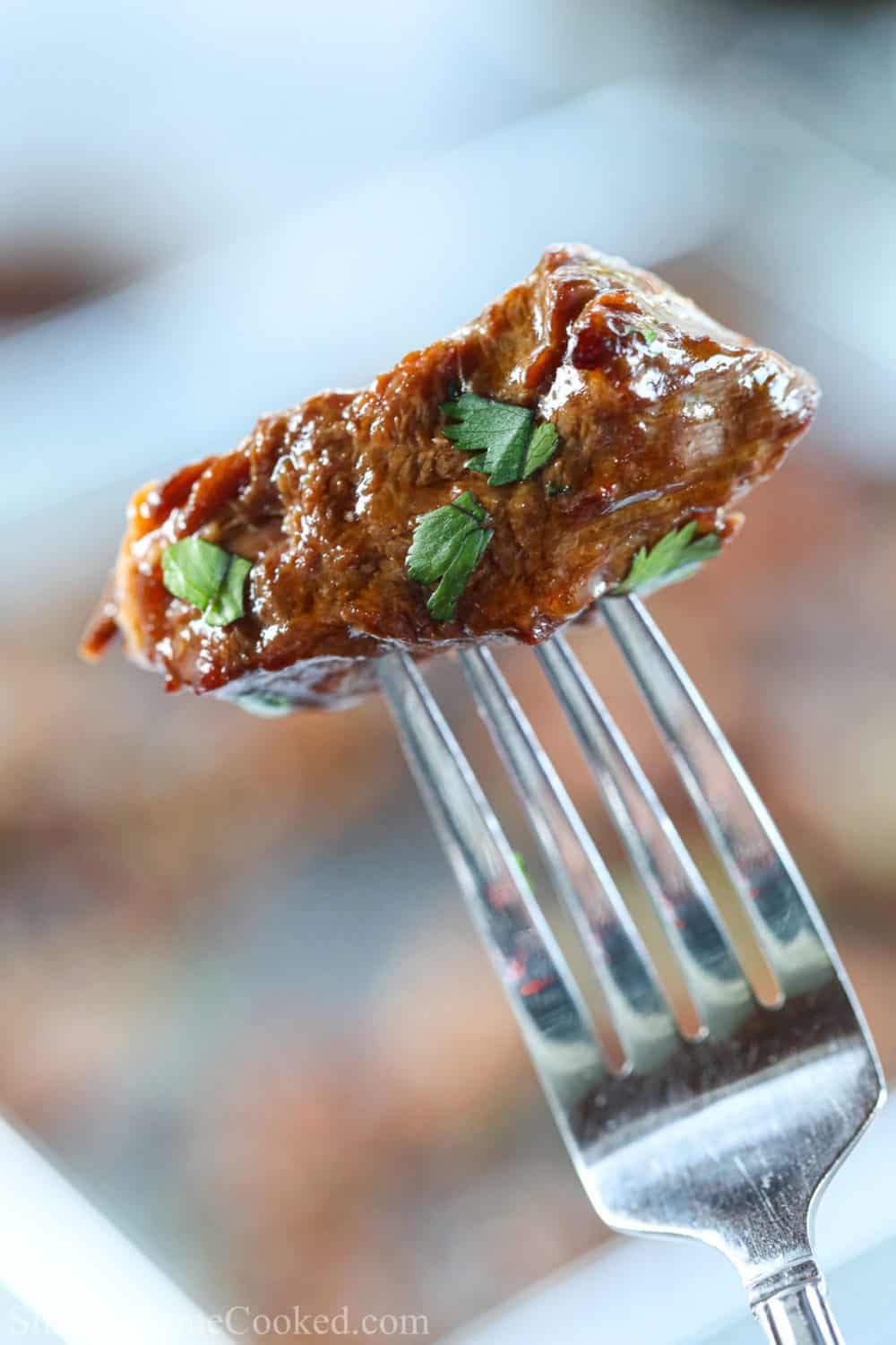 Air fryer steak bite on the tip of a fork.