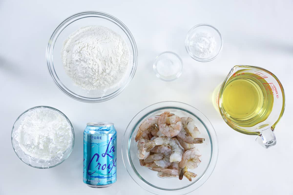 Ingredients for shrimp tempura batter, including flour, cornstarch, baking powder, salt, club soda, oil, and shrimp.