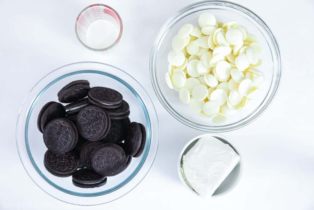Ingredients for Oreo cake balls, including Oreo cookies, heavy cream, white candy melts, and cream cheese.