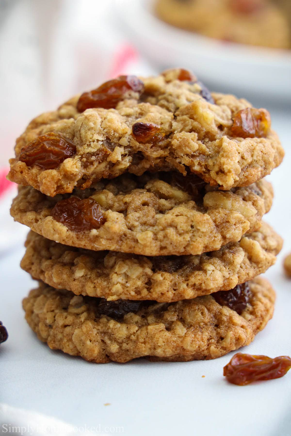 Pile of Oatmeal Raisin Cookies with one missing a bite.