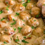 Closeup of Perfect Swedish Meatballs with a wooden spook scooping one up.