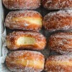 Pan full of Perfect Sugar Donuts, with one in the middle missing a bite.