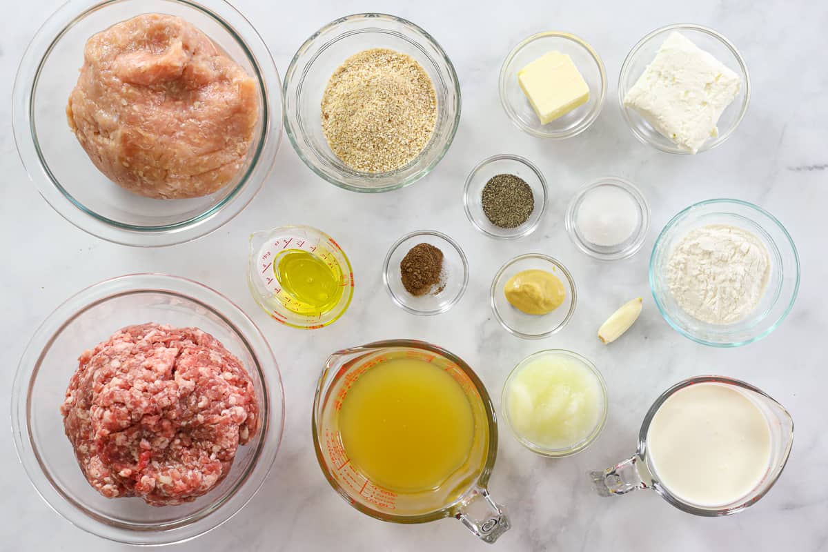 Ingredients for Perfect Swedish Meatballs including Ground pork, Ground chicken, Yellow onion, Garlic clove, Salt, Pepper, Cream cheese, Plain breadcrumbs, Allspice, and Avocado oil,  Unsalted butter, Olive oil, All-purpose flour, Chicken stock, Dijon mustard, Heavy cream, Salt, Pepper, and Allspice.