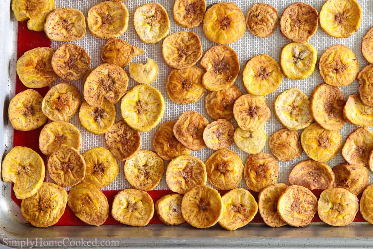 Close up of Baked Plantain Chips on a baking sheet pan. 