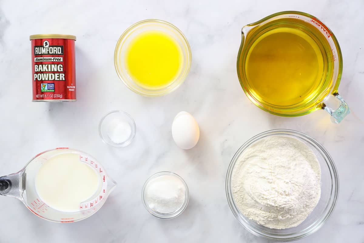 Ingredients for Homemade Donut Holes, including flour, sugar, salt, baking powder, oil, milk, egg, and melted butter.