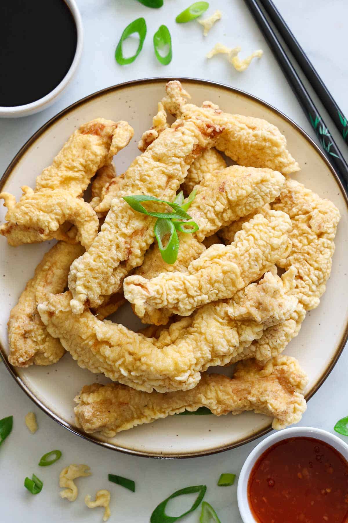 Vertical image of Chicken Tempura with sauces nearby
