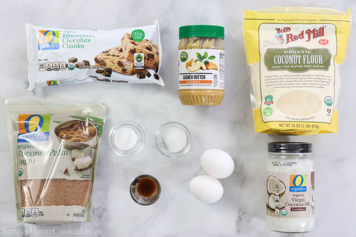 Ingredients for Coconut Flour Cookies, including coconut flour, coconut sugar, vanilla, eggs, cashew butter, coconut oil, salt, baking soda, and chocolate chunks.