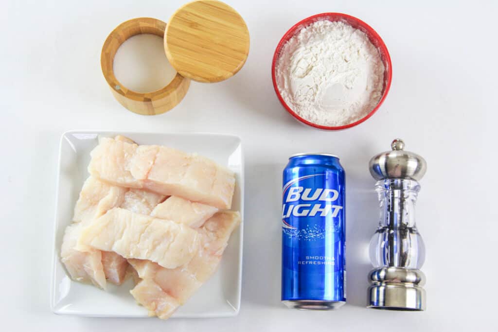 Ingredients for Beer Battered Cod, including beer, cod fillets, flour, salt, pepper, and oil.