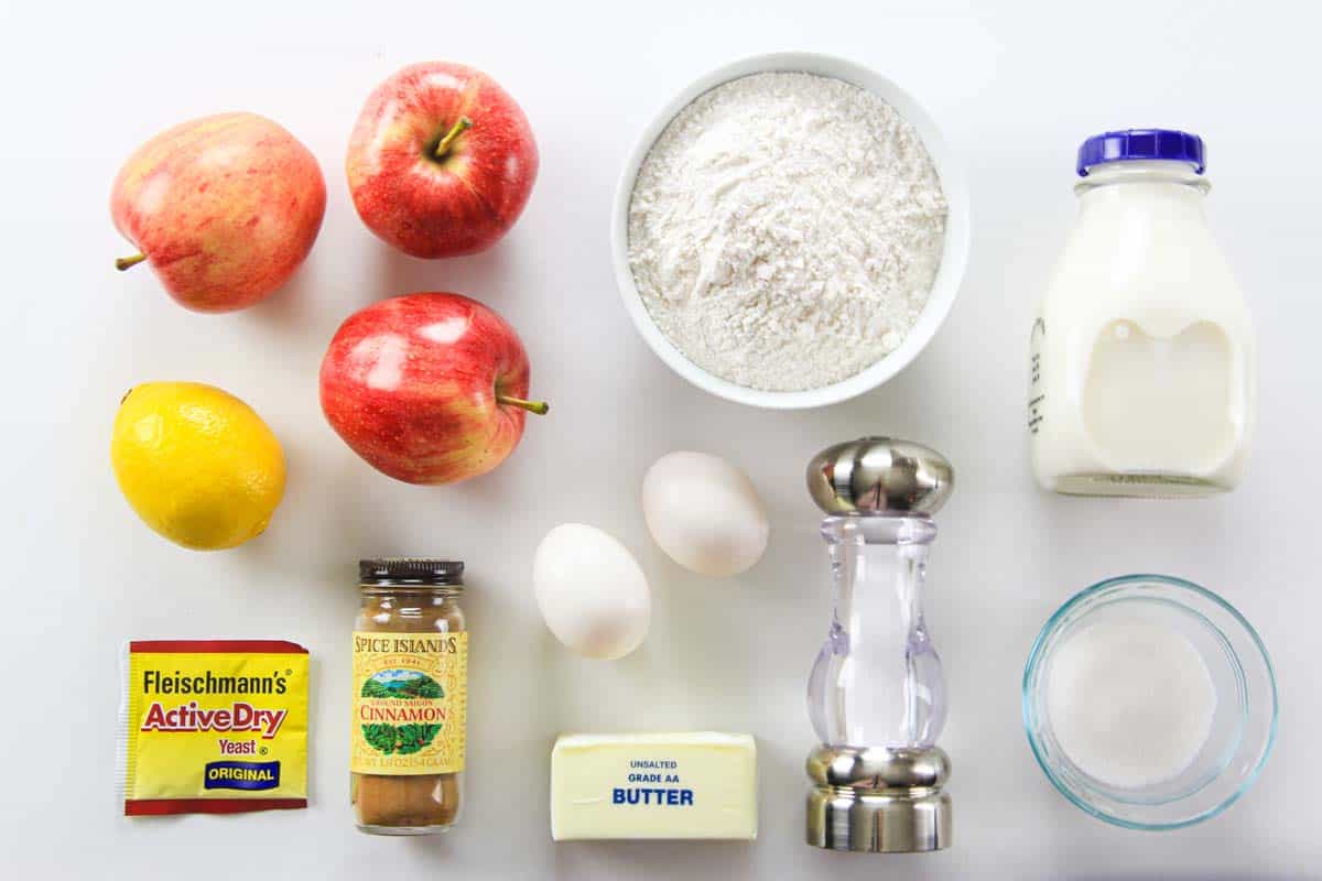 Ingredients for Apple Fritters, including apples, lemon, flour, milk, eggs, yeast, butter, cinnamon, sugar, and salt.