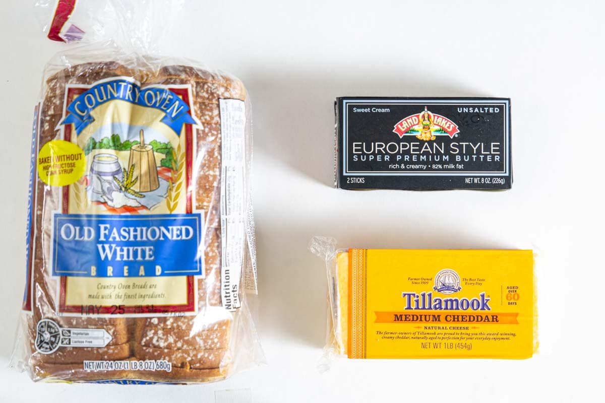 Ingredients for Grilled Cheese Sandwiches, including white bread, butter, and cheddar cheese. 