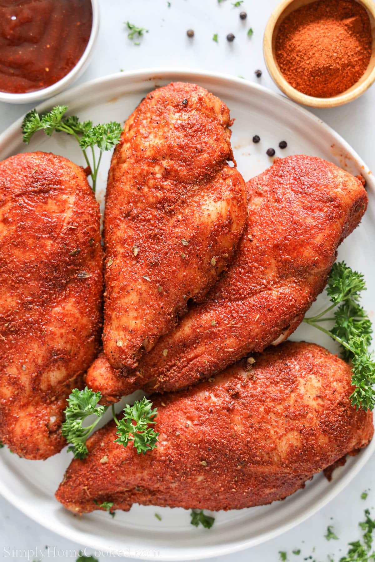 Close up of Smoked Chicken Breasts on a plate with parsley.
