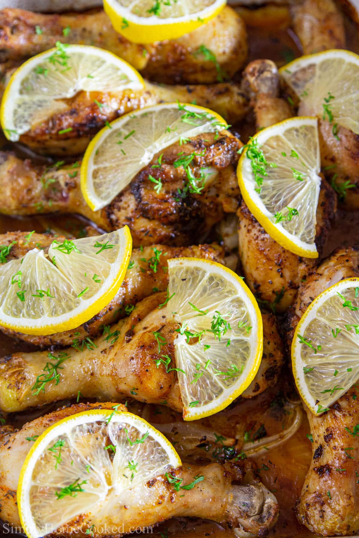 Crispy baked lemon chicken. Super easy to make, and its paleo/whole 30 approved. #bakedchicken #chickendrumsticks #lemonchicien #easychicken #chickendinner #quickchicken Vertical closeup image of Baked Chicken Drumsticks