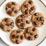 overhead image of coconut flour cookies on a white plate