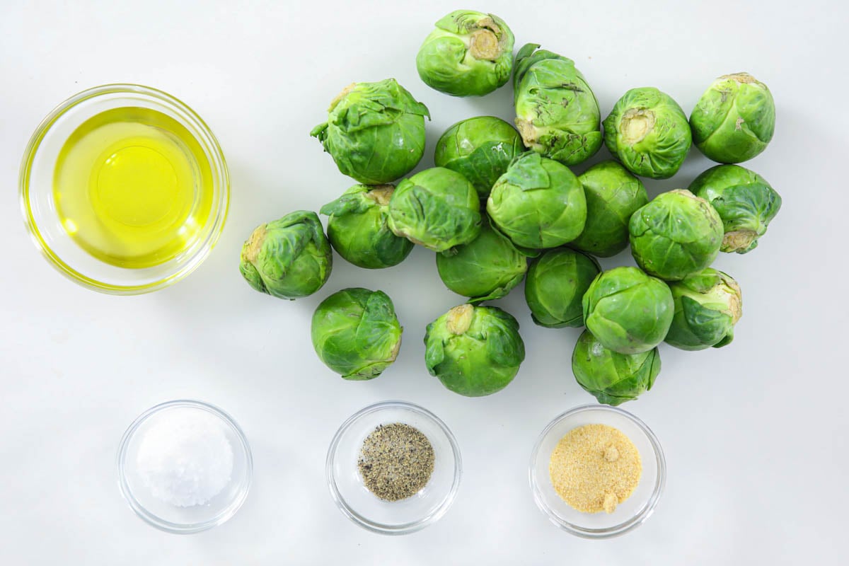 Ingredients for Air Fryer Brussels Sprouts, including brussels sprouts, oil, salt, pepper, and garlic powder.