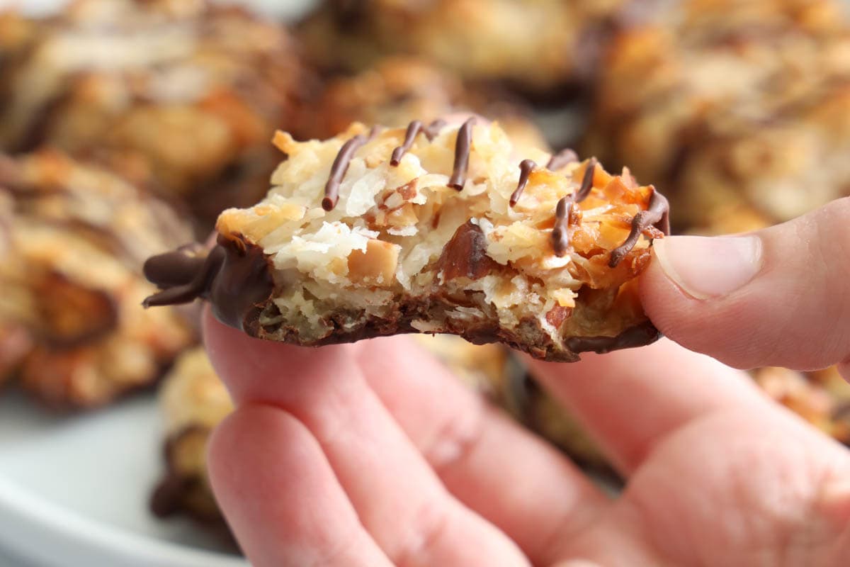 Horizontal image of Almond Joy Cookie being held, a bite missing