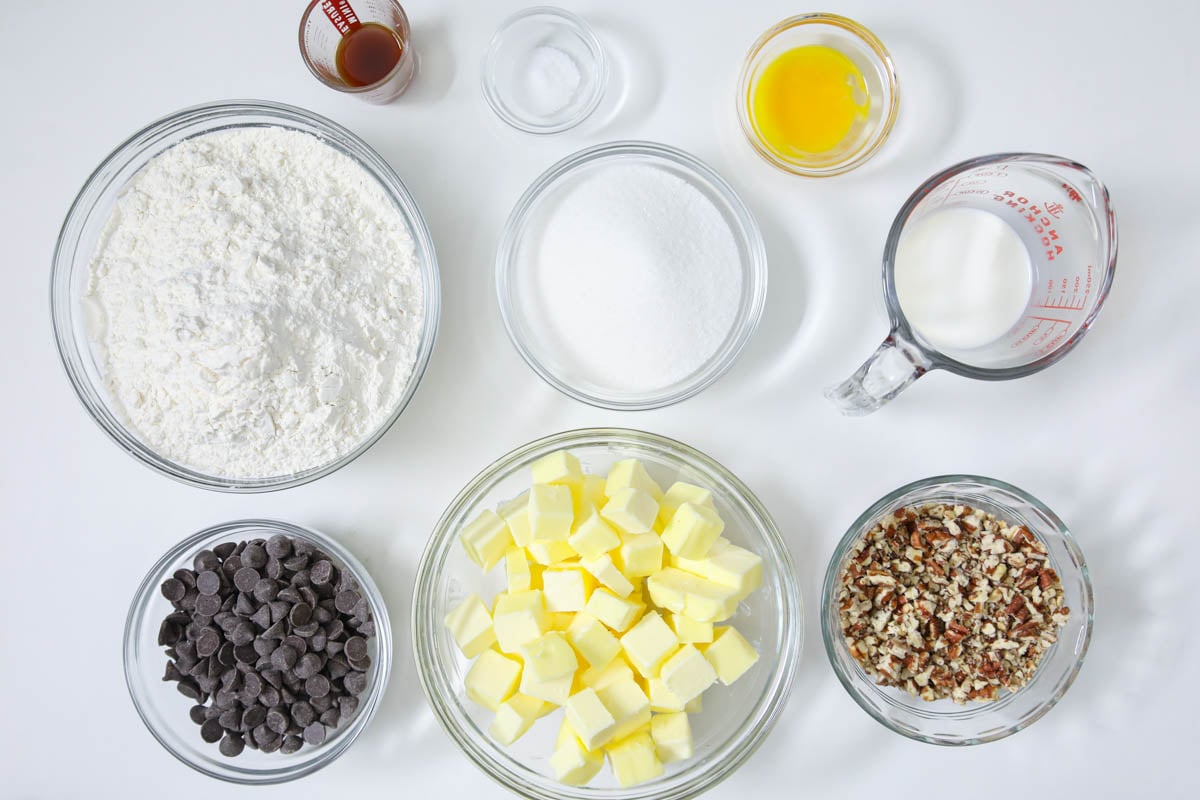 Ingredients for Chocolate Thumbprint Cookies including flour, sugar, pecans, chocolate, butter, egg, cream, vanilla, and salt. 
