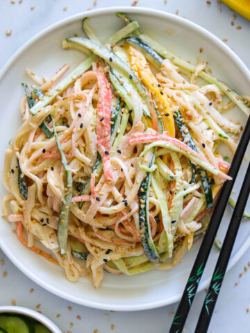 Vertical image of Kani Salad with chopsticks on the side of the plate.