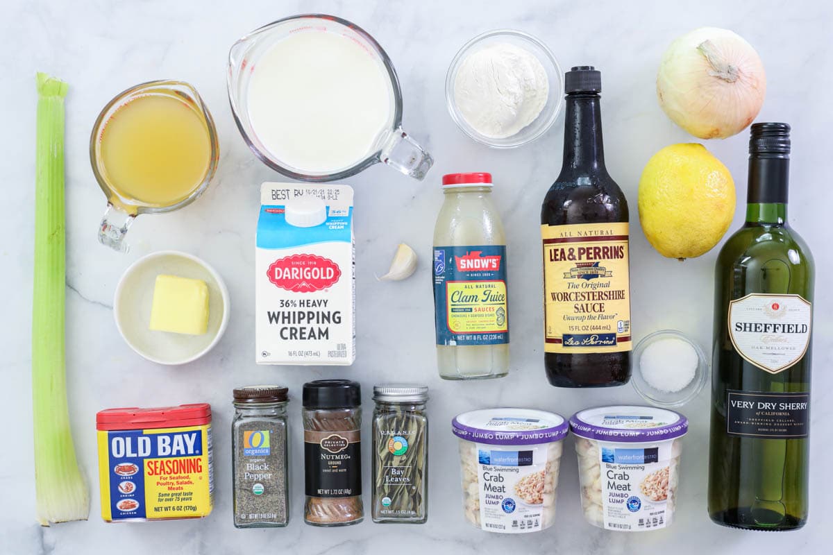 Ingredients for She Crab Soup, including celery, broth, butter, sherry, worcestshire sauce, clam sauce, crab meat, cream, salt, pepper, nutmeg, bay leaves, old bay seasoning, onion, lemon, garlic, flour, and milk.