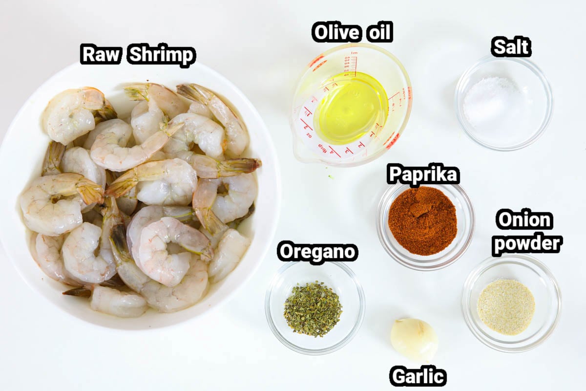 These Easy Blackened Cajun Shrimp are so flavorful & only take 10 minutes to make. You can eat them on their own or add them to your favorite salad or pasta. #10minuteshrimp #easyblackenedshrimp #10minutecajunshrimp #easyshrimprecipe Ingredients for Cajun Shrimp, including shrimp, oil, paprika, oregano, onion powder, salt, and garlic.