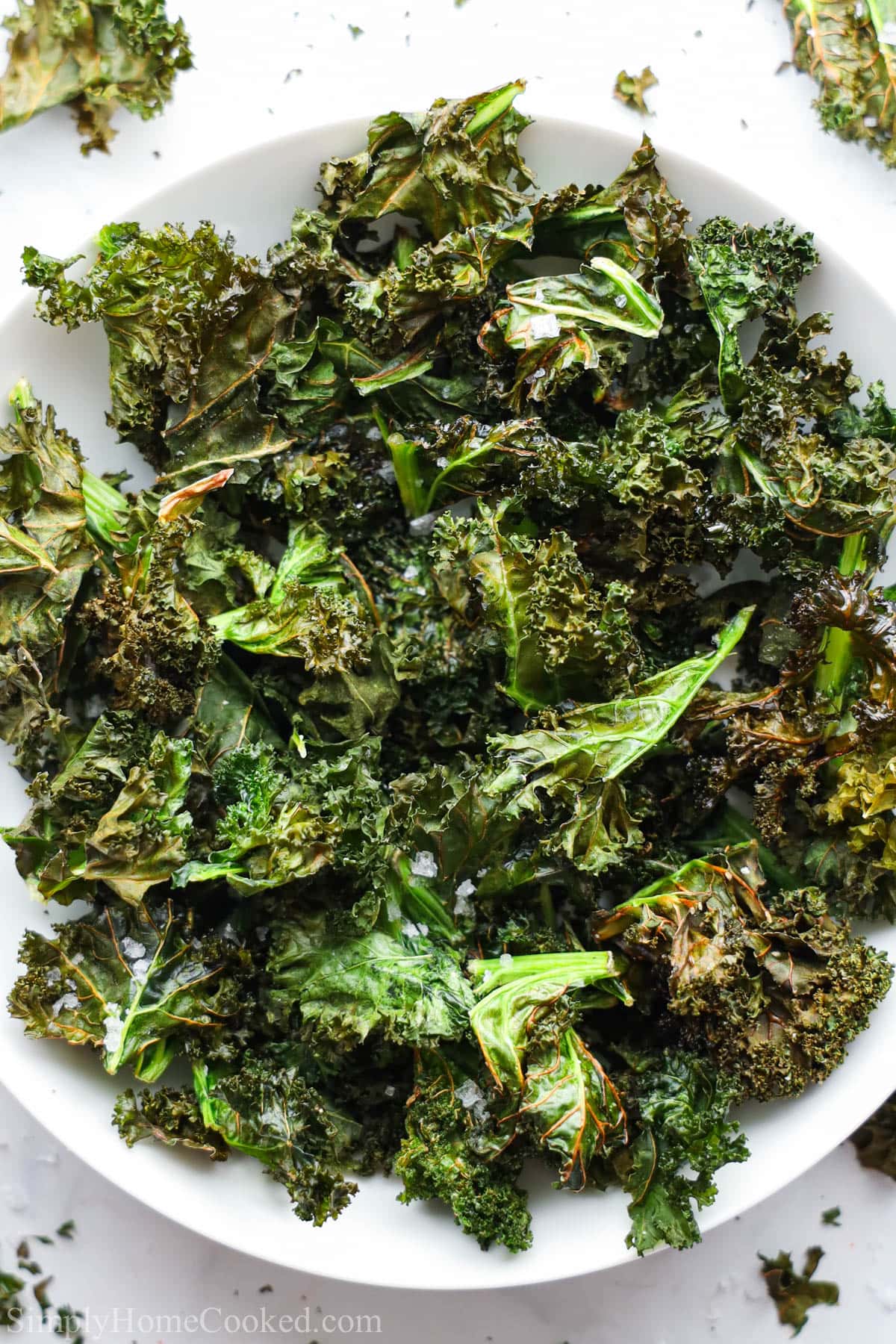 Vertical image of Air Fryer Kale Chips on a white plate