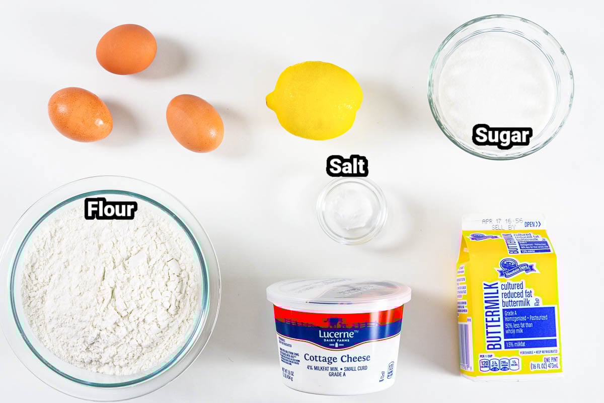 Ingredients for Cottage Cheese Pancakes, including eggs, flour, sugar, salt, lemon, cottage cheese, and buttermilk.