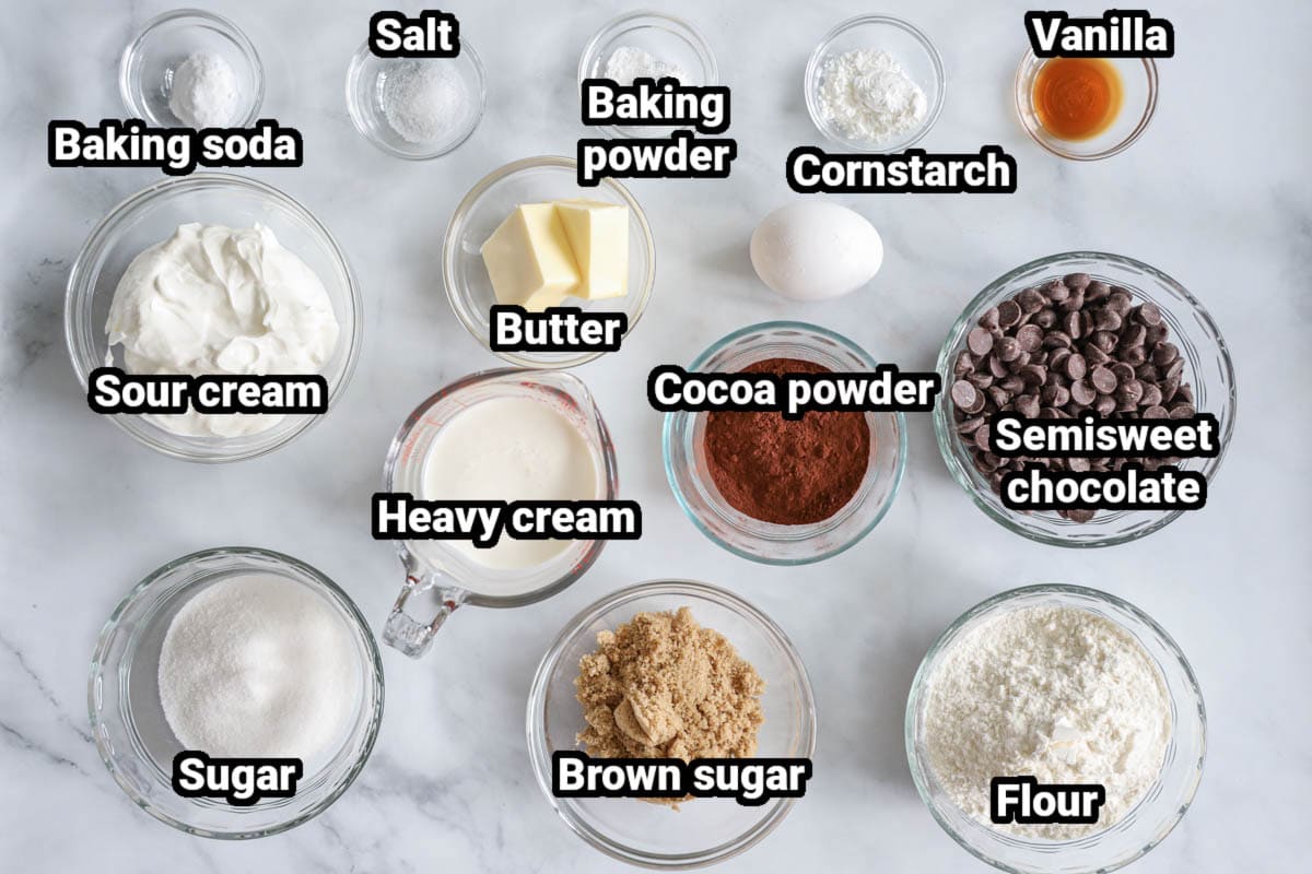 Ingredients for Chocolate Donuts, including sugar, brown sugar, flour, heavy cream, cocoa powder, semisweet chocolate chips, butter, sour cream, egg, cornstarch, vanilla, baking powder and soda, and salt. 