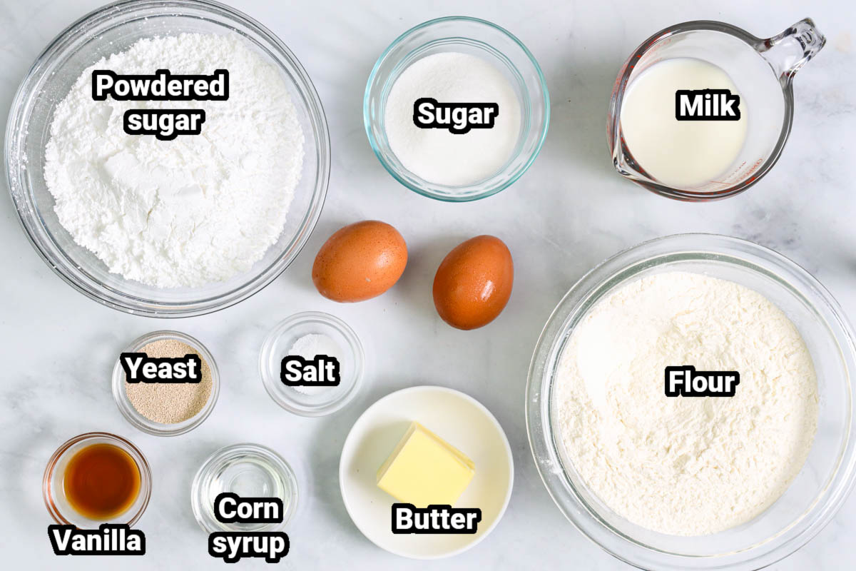 Ingredients for Glazed Air Fryer Donuts, including flour, sugar, powdered sugar, milk, eggs, salt, yeast, corn syrup, vanilla and butter.