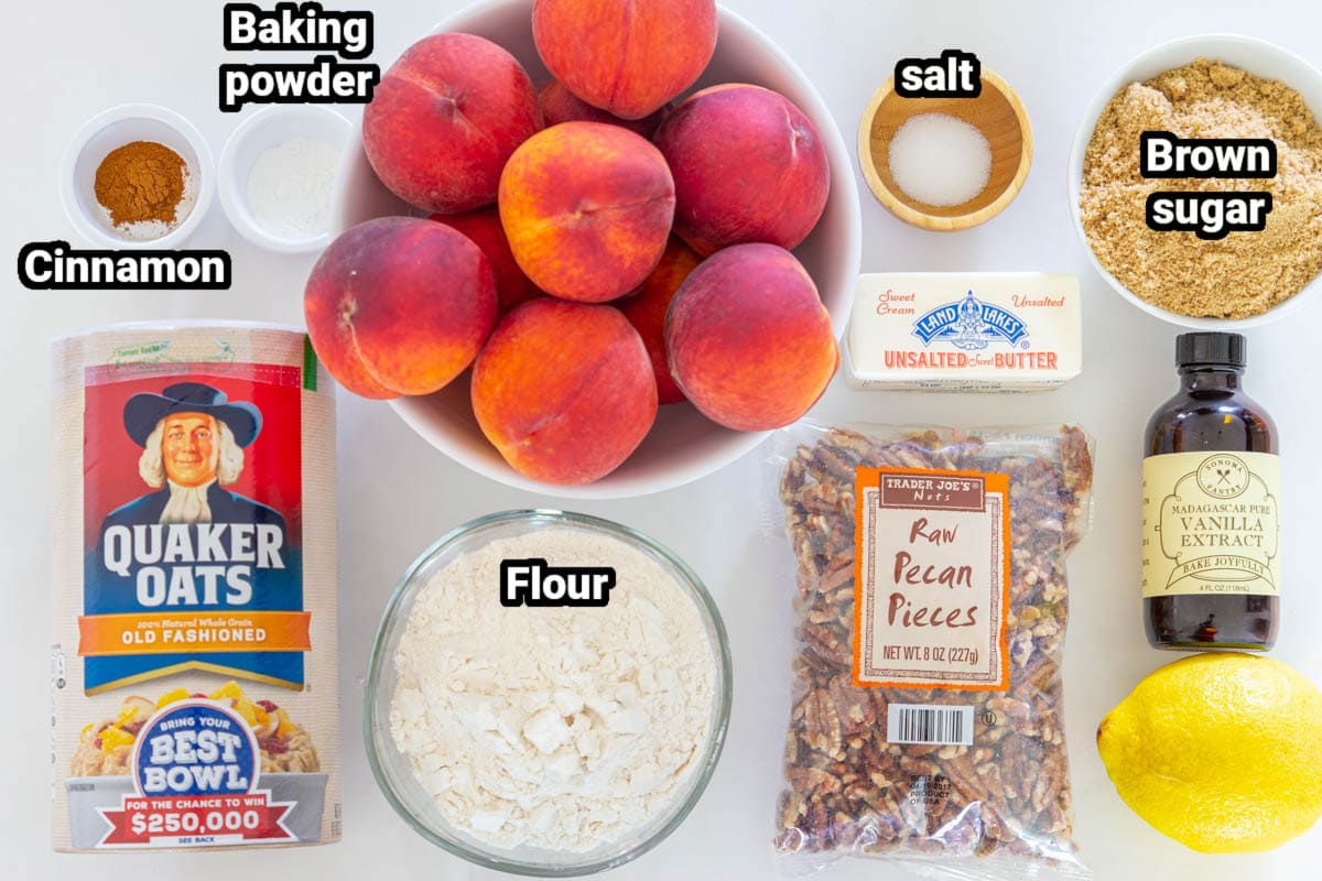 This EASY Peach Crisp Recipe is unbelievably delicious! Bursting with flavor from the fresh peaches that are covered with a sweet streusel oat topping! #peachcrisp #crisprecipe #peachdessert #bakedpeaches Ingredients for Peach Crisp, including peaches, oats, baking powder, cinnamon, salt, brown sugar, butter, lemon juice, flour, pecans, and vanilla.