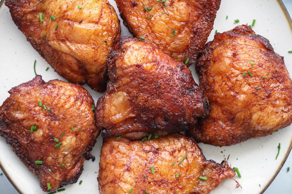 Smoked Chicken Thighs on a white plate.