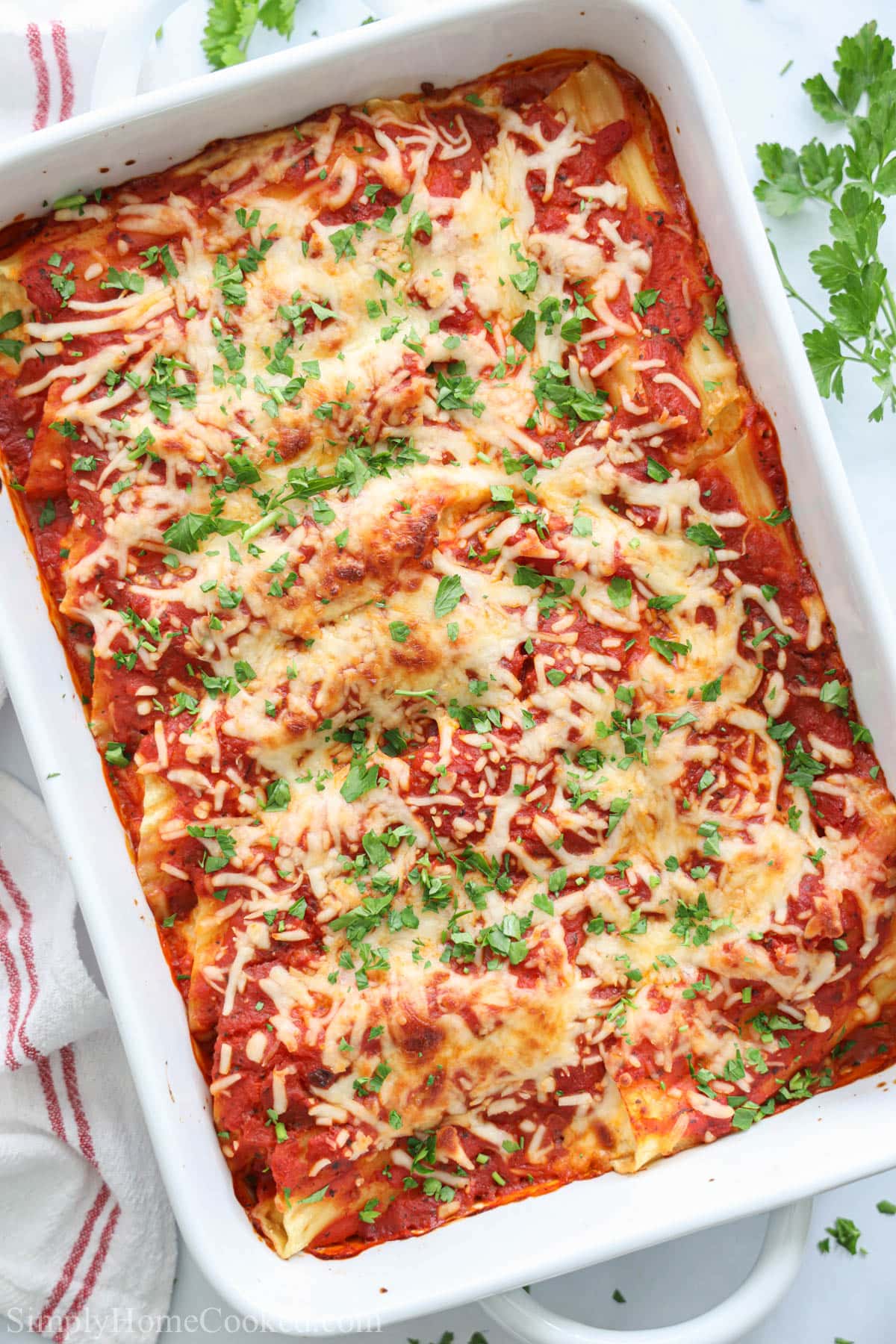 Stuffed Manicotti in a white baking dish