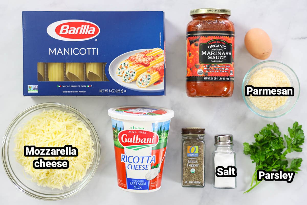 Ingredients for Stuffed Manicotti, including manicotti shells, marinara sauce, mozzarella, ricotta, parmesan, egg, parsley, salt, and pepper.