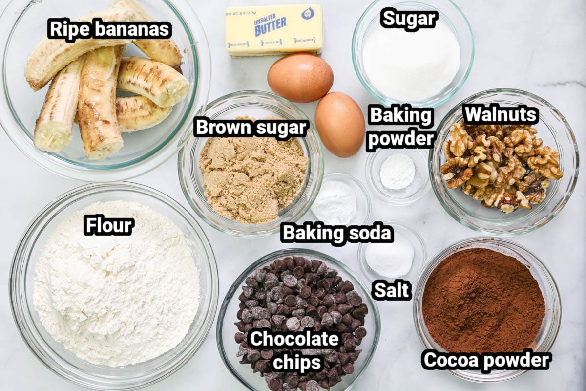This Double Chocolate Banana Bread recipe is so amazing! Rich and moist with bananas, two types of chocolate, and toasted walnuts, it is decadent and delicious. #deliciousbananabread #doublechocolatebananabreaddessert #bestbananabread #bestchocolatebananabread Ingredients for Double Chocolate Banana Bread: bananas, sugar, brown sugar, butter, eggs, baking powder, salt, baking soda, walnuts, flour, cocoa powder, and chocolate chips.