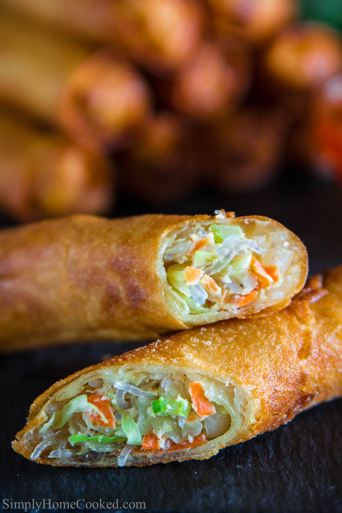Easy fried spring rolls. A simple yet super delicious Asian appetizer. #foreign #ethnic #springrolls #eggrolls #easyrecipe #asianfood #takeout #appetizer Close up of Fried Spring Rolls cut in half