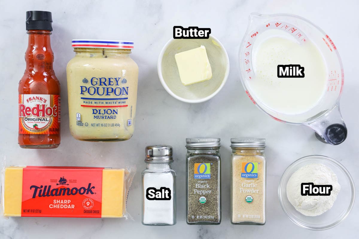 Ingredients for Pretzel Cheese Dip: hot sauce, dijon mustard, butter, milk, flour, cheese, salt, pepper, and garlic powder.