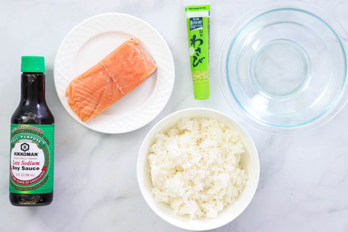 Ingredients for Salmon Nigiri: salmon fillet, wasabi paste, water, sushi rice, and soy sauce.